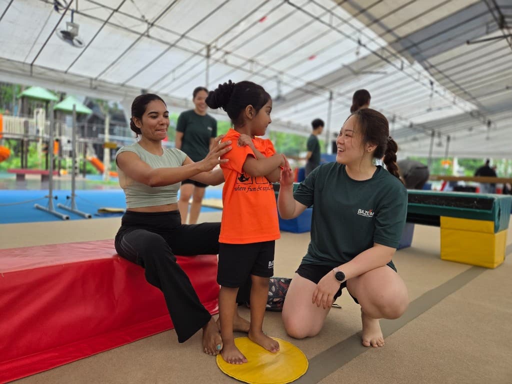 One-on-one coaching moment at BazGym Carnival