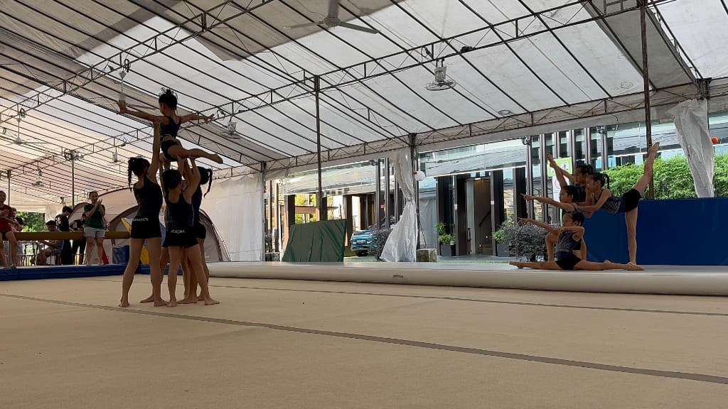 Competitive team girls performing stunts at BazGym Carnival